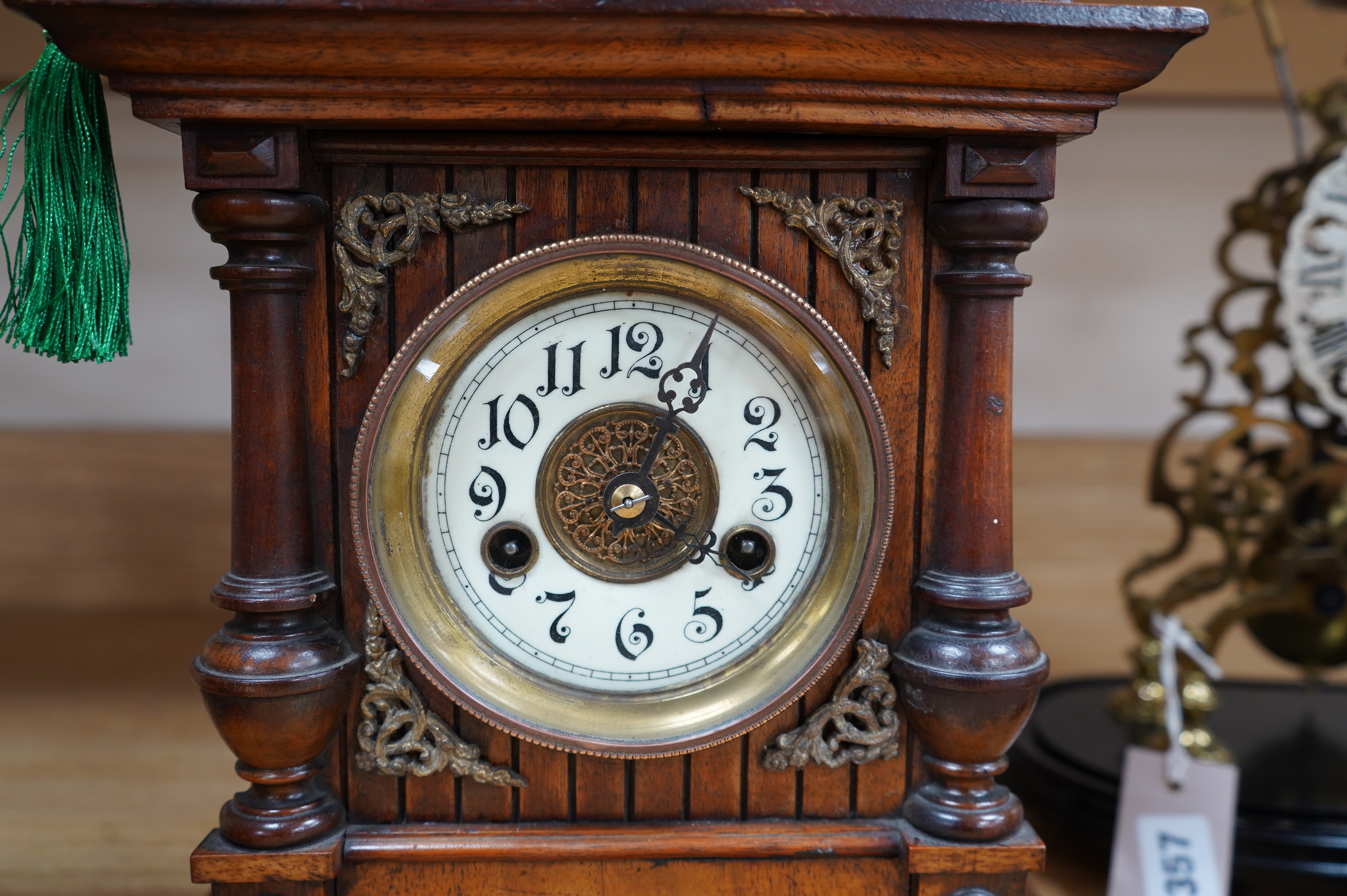 A late 19th century Black Forest walnut mantel clock with key and pendulum, 41cm. Condition - fair to good, not tested